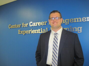man in front of CEEL logo wall